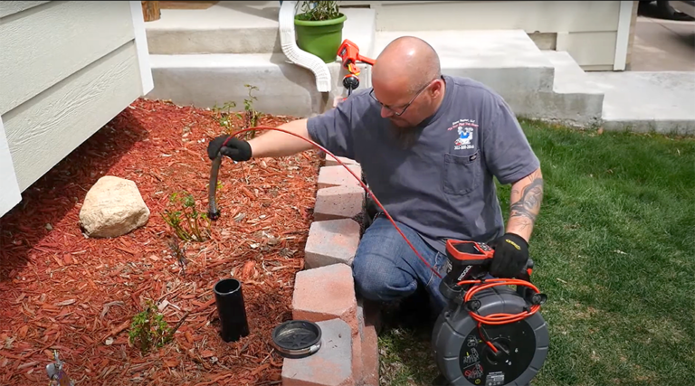 Jimmy Jr. doing a sewer camera inspection from an outside tap.